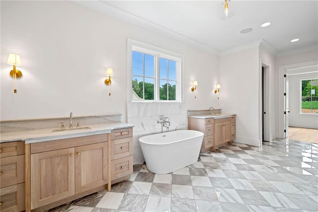 615 Claxton Ln, Milton, GA 30004 - full bathroom with two vanities, a soaking tub, and crown molding
