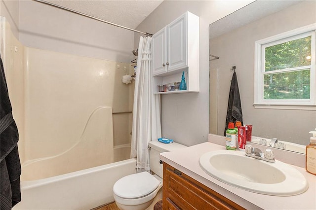 full bathroom with a textured ceiling, shower / tub combo, toilet, and vanity