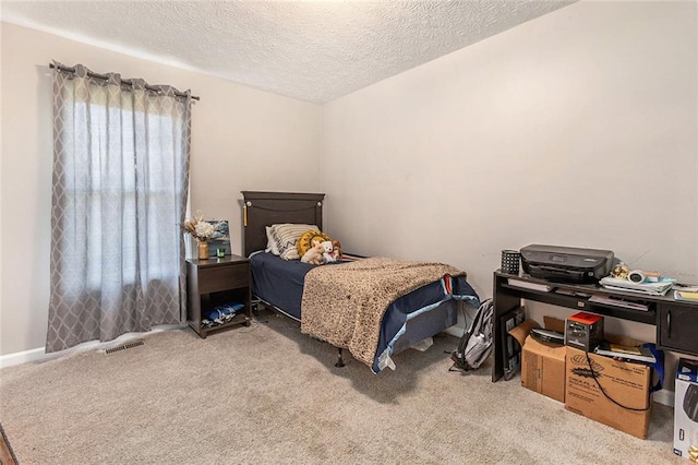 carpeted bedroom with a textured ceiling