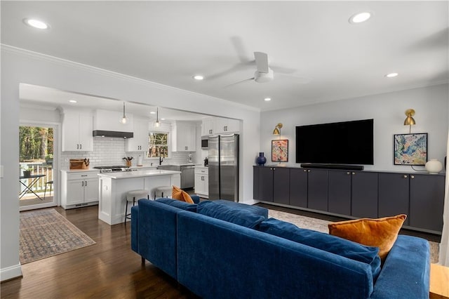 1055 Delmont Ter, Roswell, GA 30075 - living area with ceiling fan, crown molding, dark wood-style floors, and recessed lighting