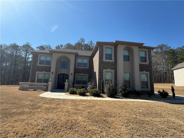 2709 Ratby Ln NE, Conyers, GA 30013 - view of front facade featuring brick siding and a front lawn