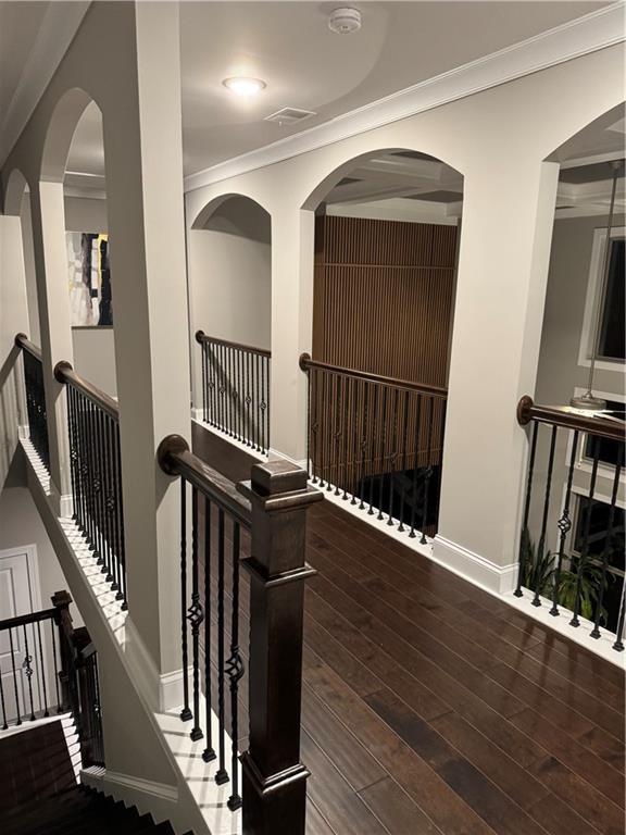 2709 Ratby Ln NE, Conyers, GA 30013 - hall with an upstairs landing, baseboards, ornamental molding, and wood finished floors