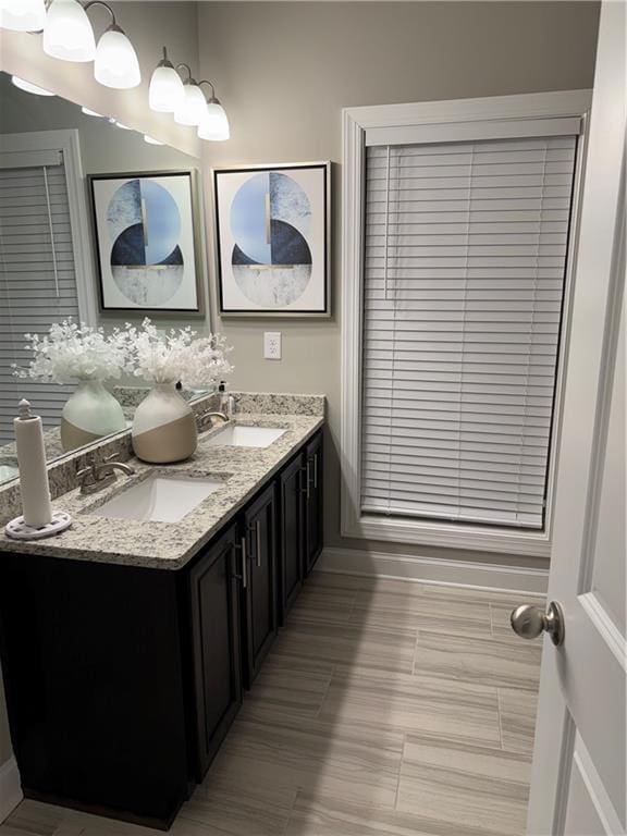 2709 Ratby Ln NE, Conyers, GA 30013 - full bathroom featuring double vanity and baseboards