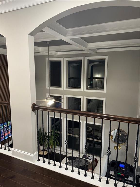 2709 Ratby Ln NE, Conyers, GA 30013 - corridor with beam ceiling, arched walkways, wood finished floors, coffered ceiling, and baseboards