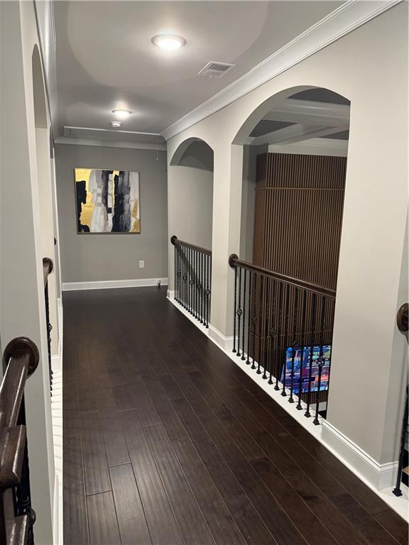 2709 Ratby Ln NE, Conyers, GA 30013 - corridor featuring ornamental molding, wood finished floors, and baseboards