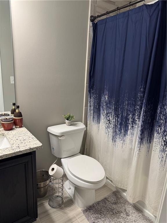 2709 Ratby Ln NE, Conyers, GA 30013 - bathroom featuring vanity, toilet, a shower with shower curtain, and wood finished floors