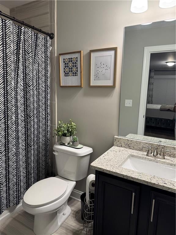 2709 Ratby Ln NE, Conyers, GA 30013 - bathroom featuring toilet, vanity, a shower with curtain, and wood finished floors