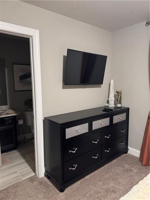 2709 Ratby Ln NE, Conyers, GA 30013 - bedroom with light carpet and connected bathroom