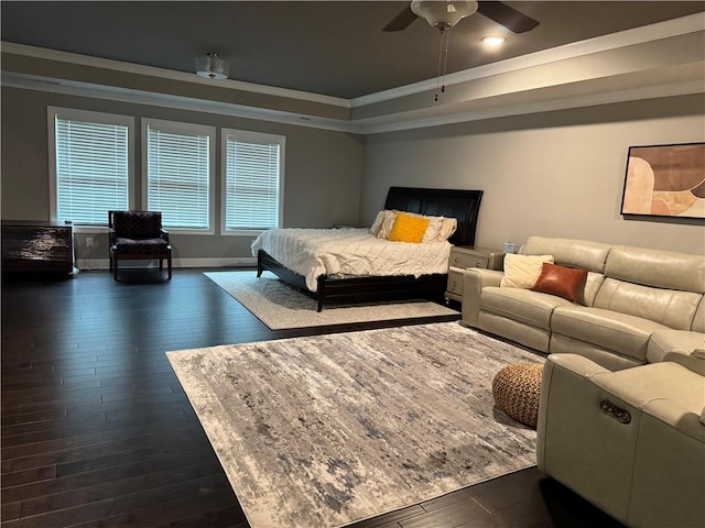 2709 Ratby Ln NE, Conyers, GA 30013 - bedroom with dark wood-style floors, ornamental molding, a tray ceiling, a ceiling fan, and baseboards