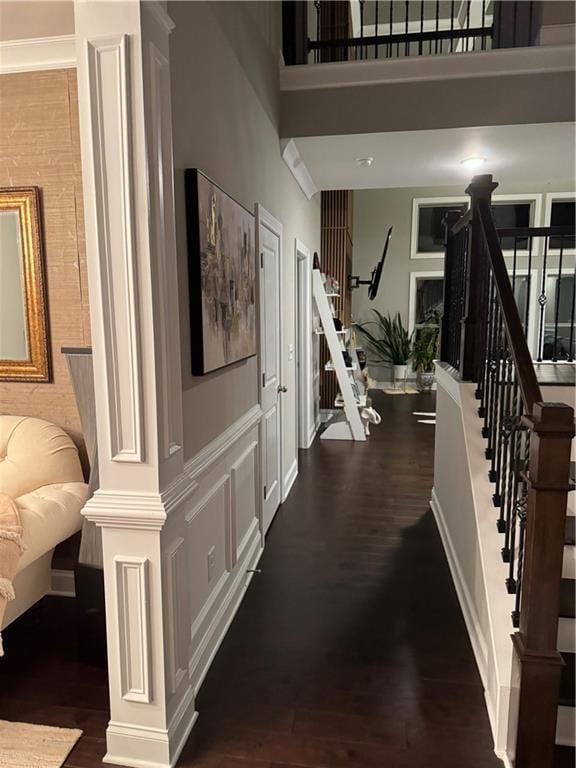 2709 Ratby Ln NE, Conyers, GA 30013 - stairway with wood finished floors, a high ceiling, and ornate columns