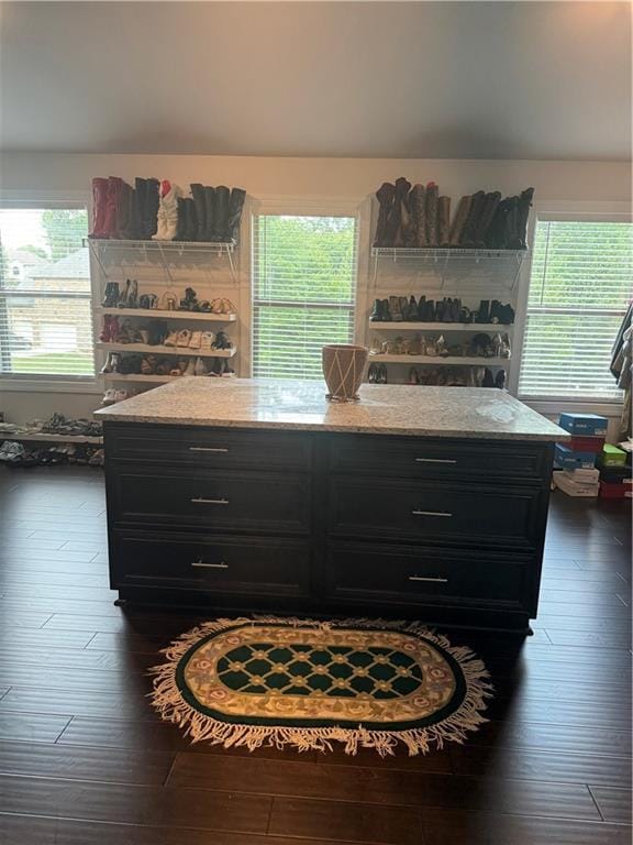 2709 Ratby Ln NE, Conyers, GA 30013 - kitchen featuring dark cabinetry, dark wood-style flooring, and light stone countertops