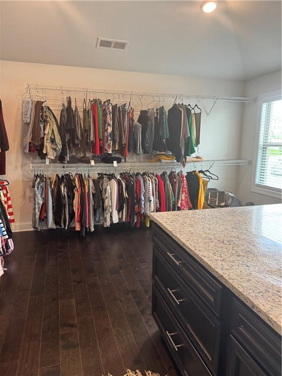 2709 Ratby Ln NE, Conyers, GA 30013 - walk in closet featuring dark wood-style flooring