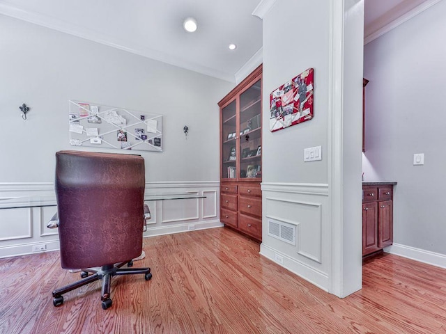 office area with ornamental molding, light wood-type flooring, wainscoting, recessed lighting, and a decorative wall