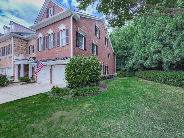 view of front of house featuring brick siding, driveway, a garage, and a front yard