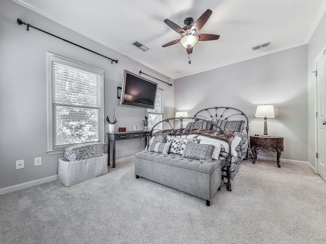 carpeted bedroom with crown molding, baseboards, and ceiling fan