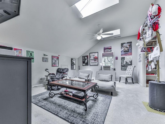 carpeted living room featuring a skylight, lofted ceiling, ceiling fan, and baseboards
