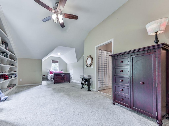 bedroom with vaulted ceiling, light carpet, baseboards, and a ceiling fan