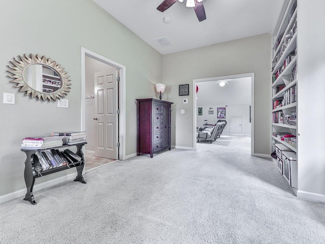 corridor featuring light colored carpet and baseboards