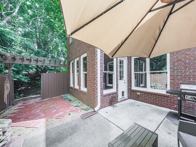 view of patio featuring fence and area for grilling