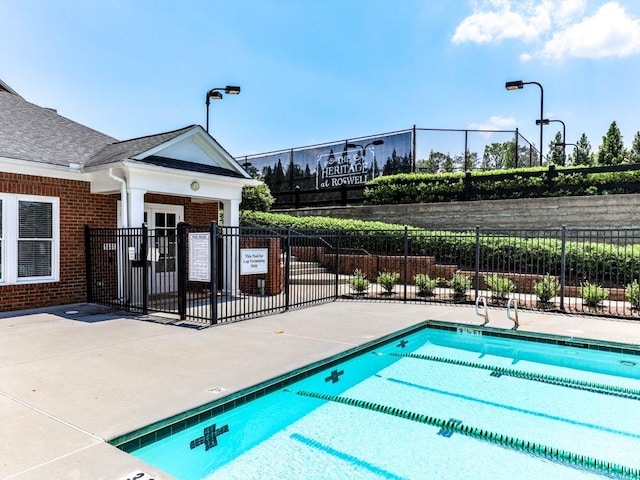 community pool featuring fence