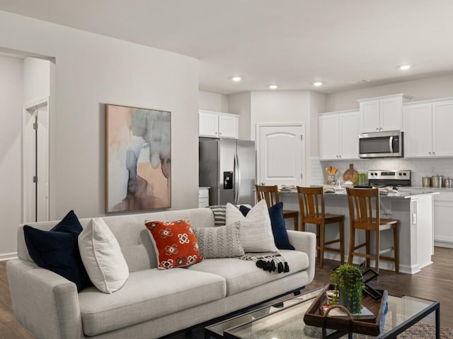 living area featuring dark wood finished floors and recessed lighting