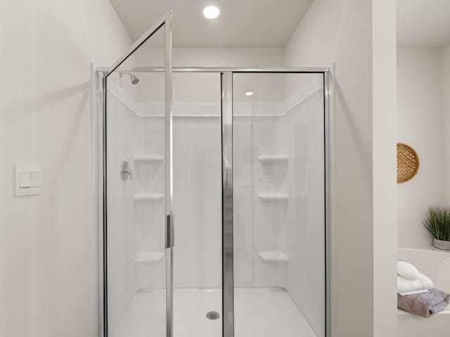 full bathroom with a shower stall and recessed lighting