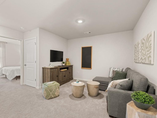 living room with carpet and baseboards