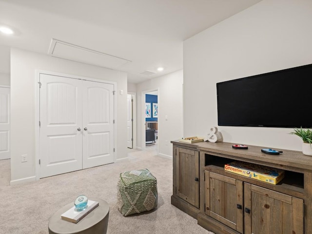 living area with attic access, light carpet, baseboards, and recessed lighting
