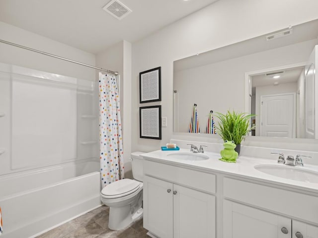 bathroom with toilet, double vanity, and shower / bath combo