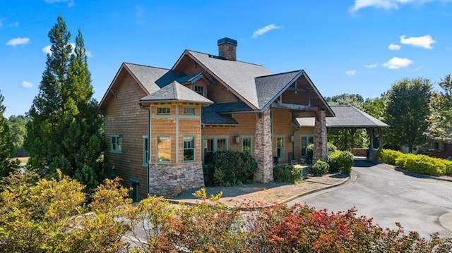 view of home's exterior featuring a chimney and stone siding