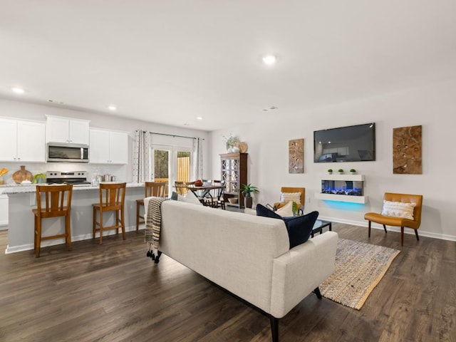 living area featuring recessed lighting and dark wood-style floors