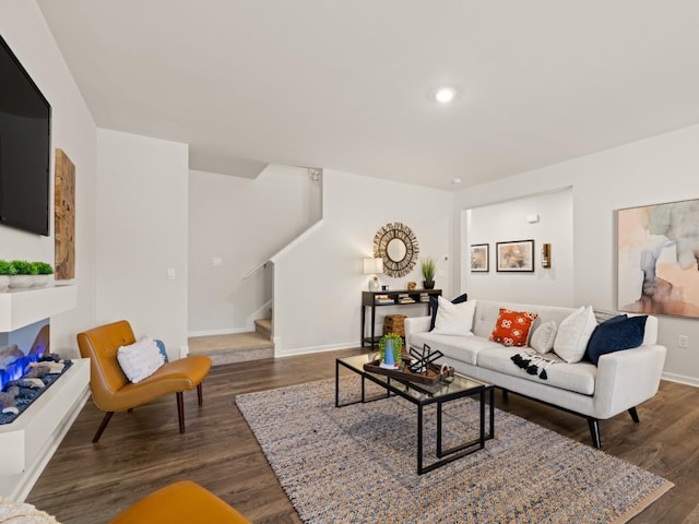 living area with stairs, dark wood-type flooring, baseboards, and recessed lighting