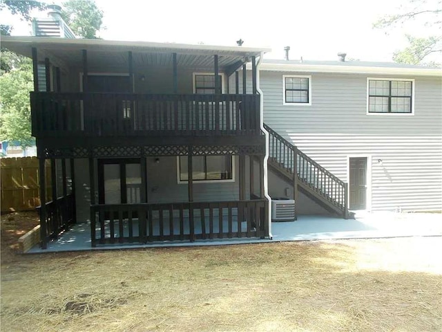 rear view of property featuring central air condition unit, a patio area, and stairs