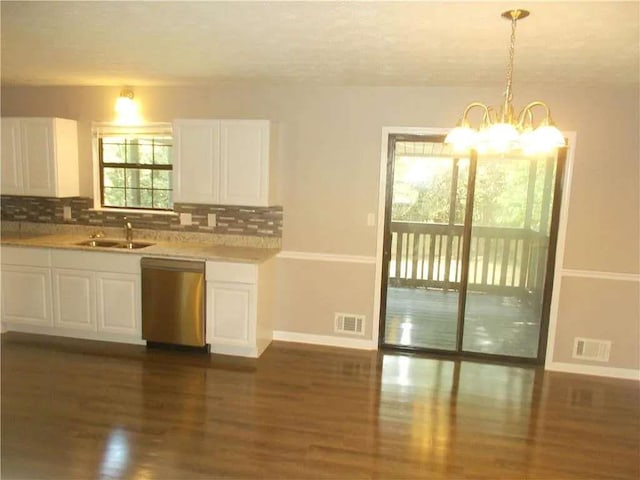 kitchen with a sink, visible vents, dark wood finished floors, dishwasher, and baseboards