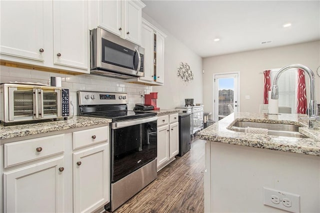 kitchen featuring tasteful backsplash, sink, stainless steel appliances, and white cabinets