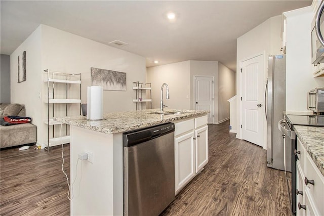 kitchen with sink, dark wood-type flooring, a kitchen island with sink, stainless steel appliances, and white cabinets