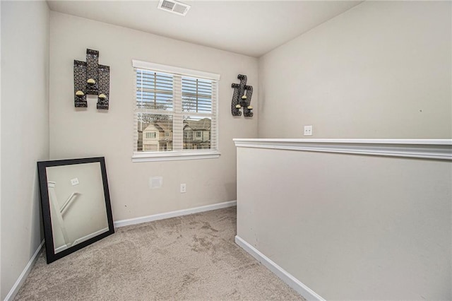 unfurnished room featuring light colored carpet