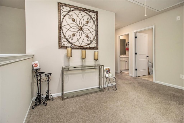 hallway featuring light colored carpet