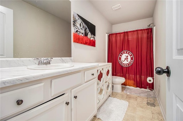 bathroom with vanity, curtained shower, and toilet