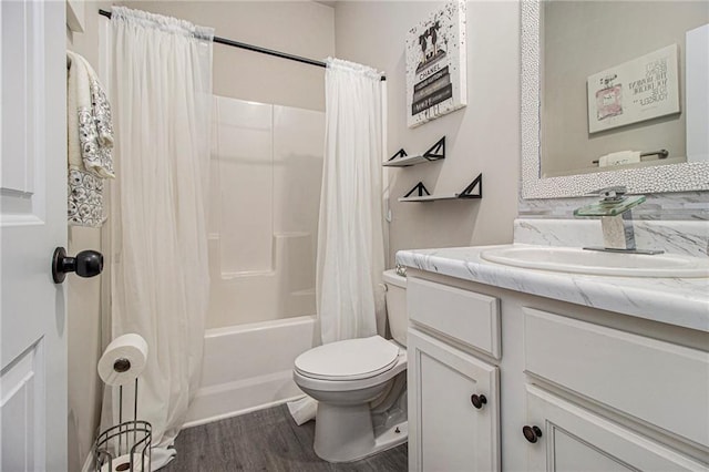 full bathroom featuring hardwood / wood-style flooring, toilet, vanity, and shower / bath combo with shower curtain