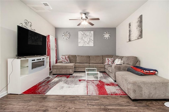 living room featuring ceiling fan and wood-type flooring