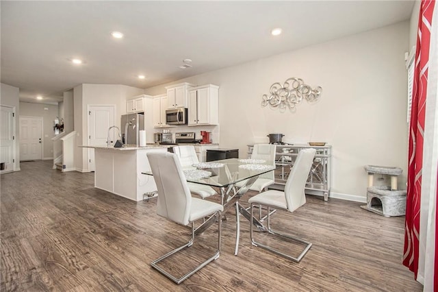 dining room featuring dark hardwood / wood-style flooring and sink