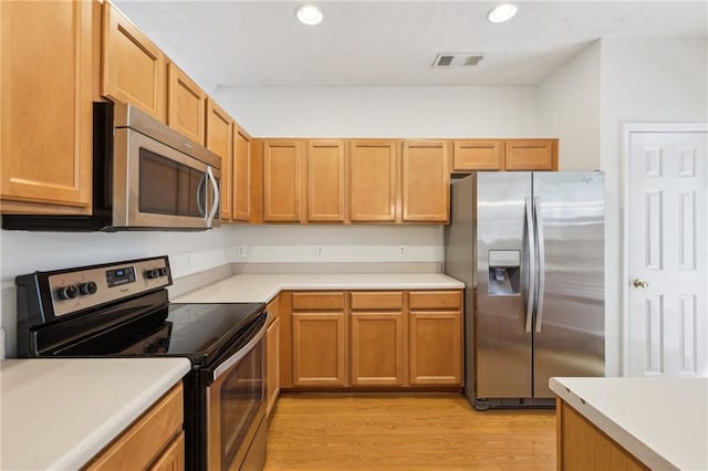 106 Weatherstone Square Dr, Woodstock, GA 30188 - kitchen with appliances with stainless steel finishes, light wood finished floors, light countertops, recessed lighting, and brown cabinetry