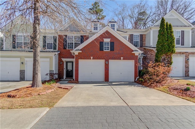 view of front of property with a garage, brick siding, and concrete driveway