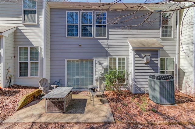 rear view of property featuring a patio and central AC