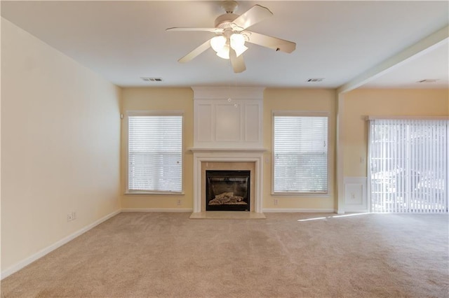 unfurnished living room featuring visible vents, a large fireplace, and carpet