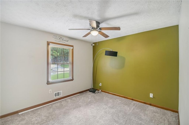 carpeted empty room with a textured ceiling and ceiling fan