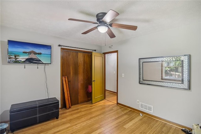 unfurnished bedroom featuring ceiling fan and light hardwood / wood-style flooring