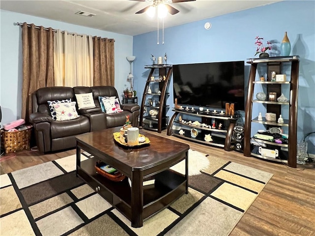 living room with ceiling fan and hardwood / wood-style floors