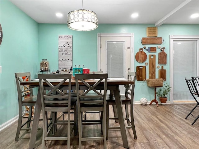 dining space with hardwood / wood-style flooring